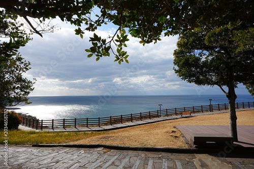 seaside cliff boardwalk and bench