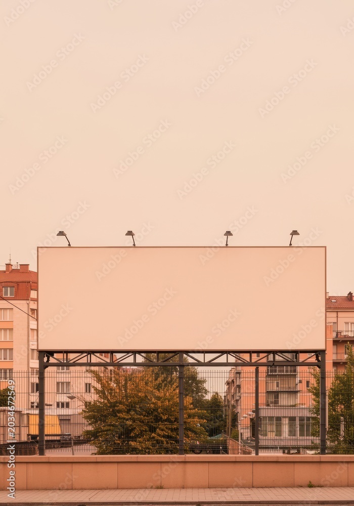 Obraz premium Large blank horizontal billboard panel mounted on a metal structure in a sunny urban setting for outdoor advertising, brand campaigns and media mockups with copy space