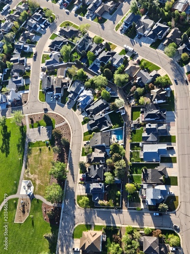 Looking down from a drone point of view at the houses in a suburban neighbourhood.