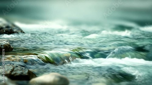 Tranquil river flowing over smooth stones in nature