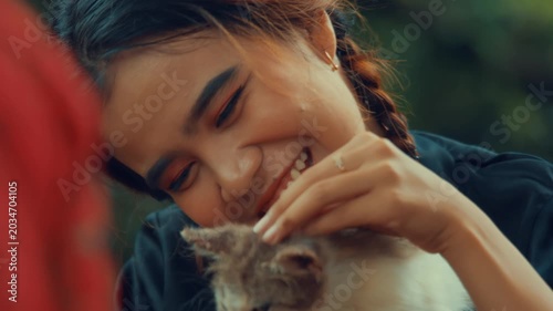Asian Girl Cuddling and Smiling with Cat