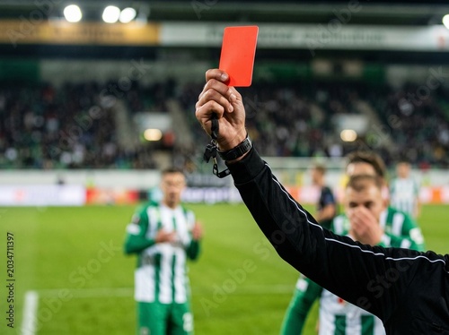 Valokuva Soccer referee showing a red card during an intense football match, symbolizing