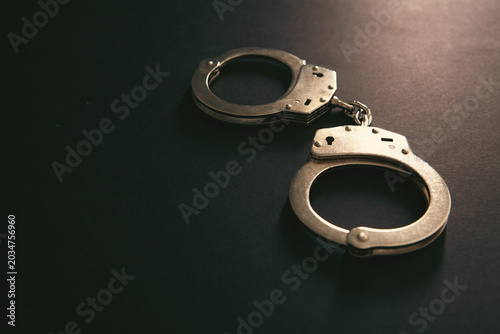 Bild auf Leinwand Handcuffs on a black background. Close-up