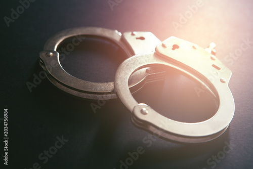 Photos Handcuffs on a black background. Close-up