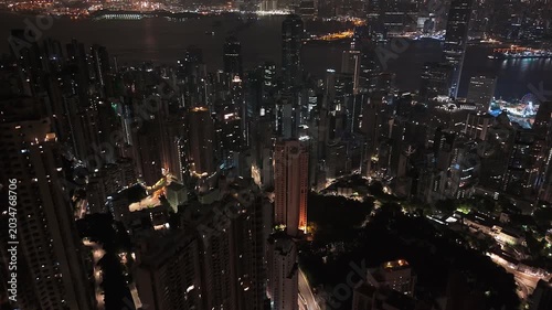 Bird's-eye view of Hong Kong dense residential towers and streets at night.