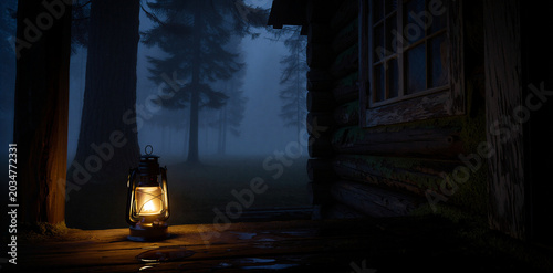 Photos Lit vintage oil lantern on a porch of a rustic wooden cabin at night