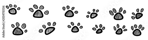 Hand drawn animal paw prints pattern on white background. Set of scribble dog or cat footprint illustrations.