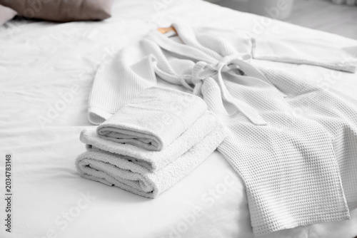 White bathrobe and folded t...