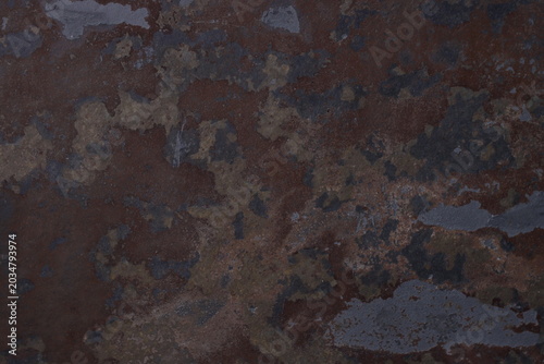 Foto Rust stains spread across darkened metal surface
