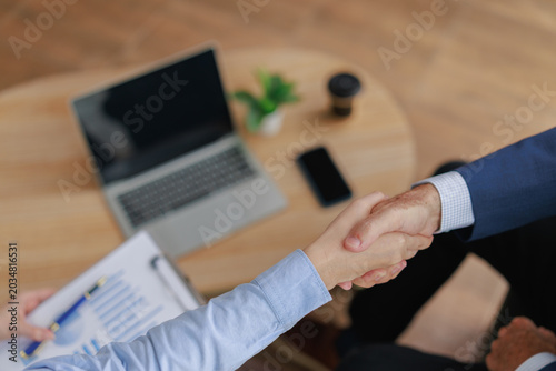 Foto Business people shaking hands, confirming a partnership for a successful deal at