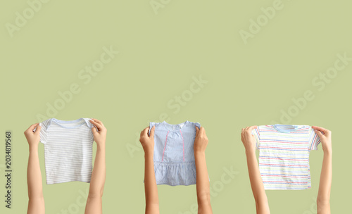 Female hands with baby clot...