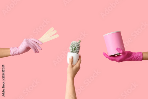 Konstfotografi Female hands with jar of sugaring paste for hair removal, sticks and cactus on pink background