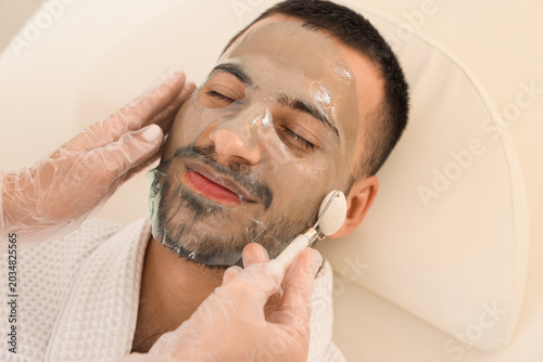Beautician applying cosmeti...