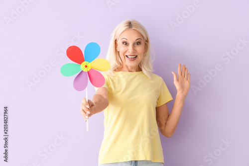 Mature woman with toy windm...