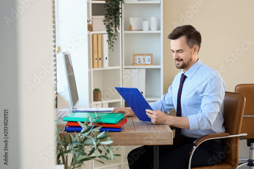 Male accountant working wit...