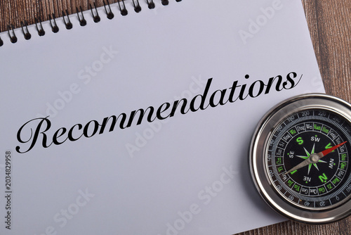 Photos Recommendations concept with compass and notebook on wooden background representing guidance, advice, consultation, strategic direction, planning, and professional support