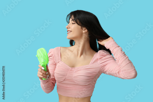 Young woman with mini fan o...