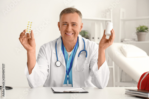 Mature doctor with pills vi...