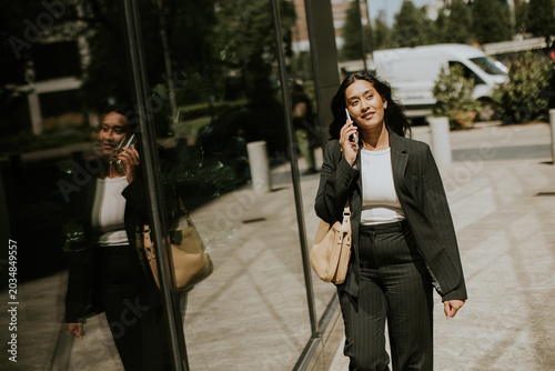 Businesswoman walking and t...