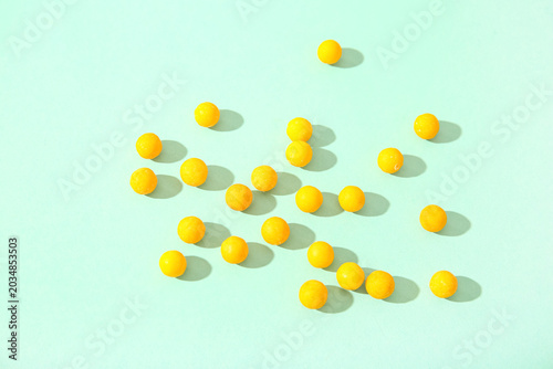 Yellow candy balls scattere...