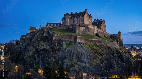 Historic Edinburgh Castle perched atop volcanic rock overlooking the city at dusk