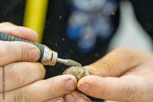 Fotografija craftsman using electric engraver to polish wood close up