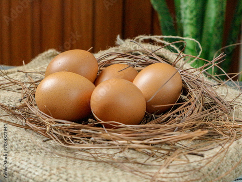 Brown Eggs in Nest on Burlap with Rustic Background