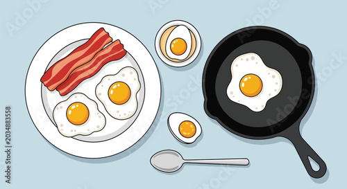 Quadro su tela Breakfast scene with fried eggs bacon and boiled eggs on plate and in pan with spoon overhead view flat lay food photography for morning meal