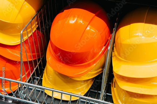 Safety helmets stacked in metal racks