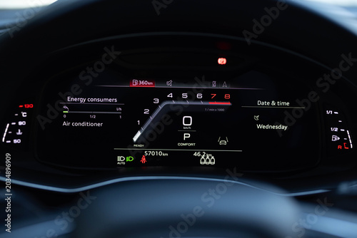 Hybrid car digital display panel. Starting car engine. Tachometer Gauge of Starting and Stopping Car. Many different car dashboard lights illuminated. Petrol meter on black background.