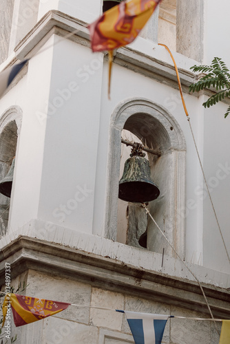 Принти на полотні Old bell tower with flags in Greece traditional architecture