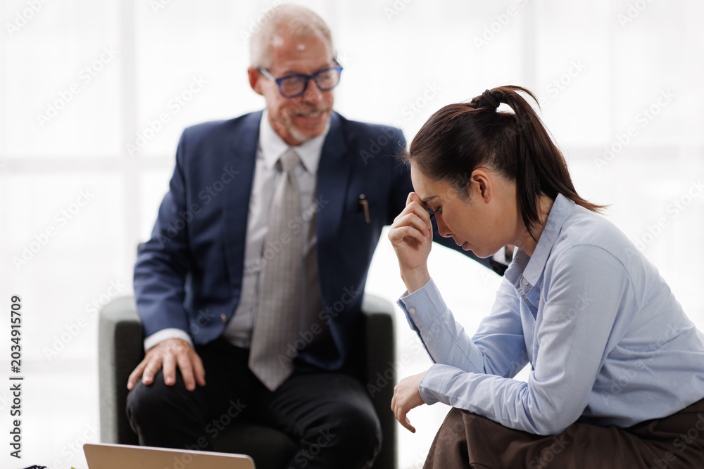 Fototapeta premium Counseling session finding professional support for a stressed businesswoman experiencing emotional distress and anxiety, receiving empathetic guidance from a male therapist