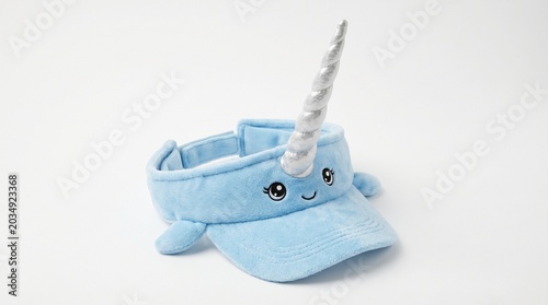 Cute blue narwhal plush visor hat isolated on white background