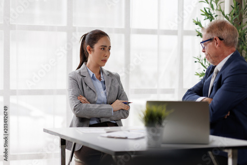 Foto Businesswoman crossing arms, upset and stressed during a tense office disagreeme