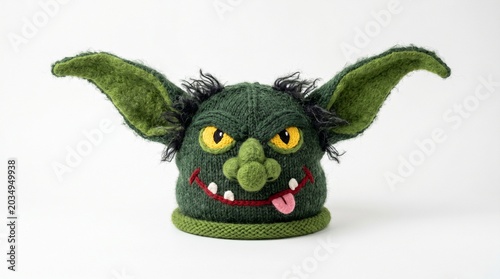 Handknitted green goblin hat with large ears isolated on white background