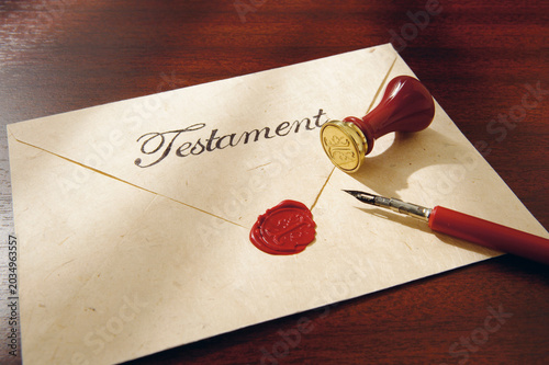Close up of last will with testament seal and feather pen