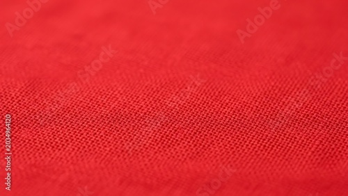 Macro view of a vibrant red woven fabric texture
