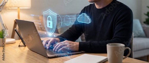 Man working on laptop with cybersecurity concept shield and lock icons cloud storage secure online workspace