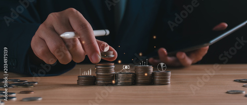 Businessman with stack growth coins. long-term financial planning, wealth management strategy, investment portfolio diversification, and capital accumulation. corporate revenue budgeting, banking.