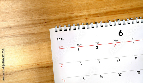2026 calendar, June 2026 desk calendar on a wooden desk, 2026 New Year's plans.