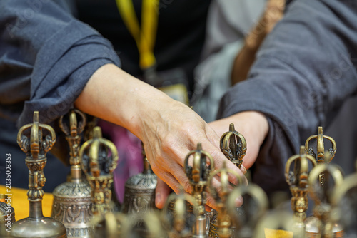 Photos People selecting and arranging Tibetan bronze vajra bell ritual implements
