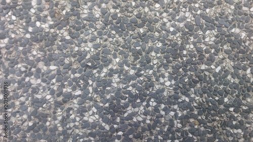 Bild auf Leinwand Close up of pebble finish concrete surface showing embedded dark and light stone