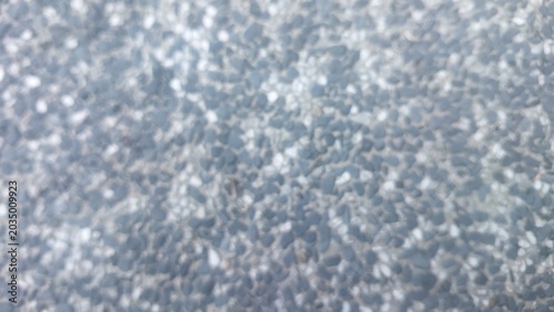 Foto Blurred close-up of textured aggregate pavement, emphasizing soft focus and indi