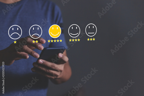 Customer Review, Young Man hand holding Smart Phone with five star to review and give 5 stars with very good results in service, Good review 5 star rating choice feedback