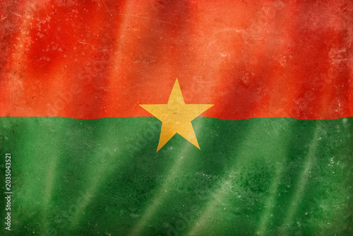 Old vintage flag of Burkina Faso, worn and stained