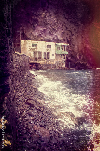 Tenerife, Canary Islands, Spain: a dilapidated house on the pebble and black-sand beach of Playa de Los Roques in Los Roques de Fasnia coastal village 