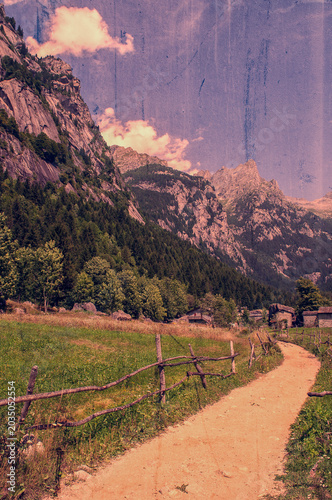 Sondrio, Italy, Europe: larches and rocks in the Val di Mello, green valley surrounded by granite mountains and forest trees, renamed the little italian Yosemite Valley by nature lovers