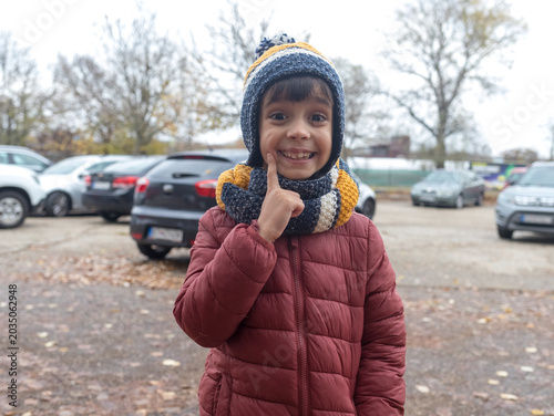 Cheerful Little Boy in Warm Winter Outfit Smiling Excitedly at Camera