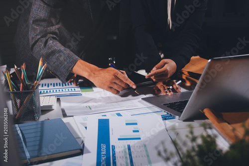 Professional photo of a person's hands reviewing a contract or legal document on a desk, for concepts of business, finance, and legal affairs