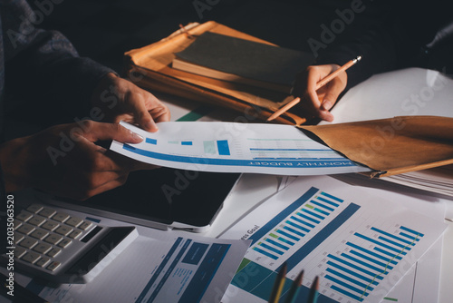 Photos Professional photo of a person's hands reviewing a contract or legal document on